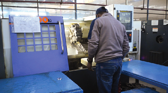 CNC machining process with automated cutting tool shaping metal workpiece